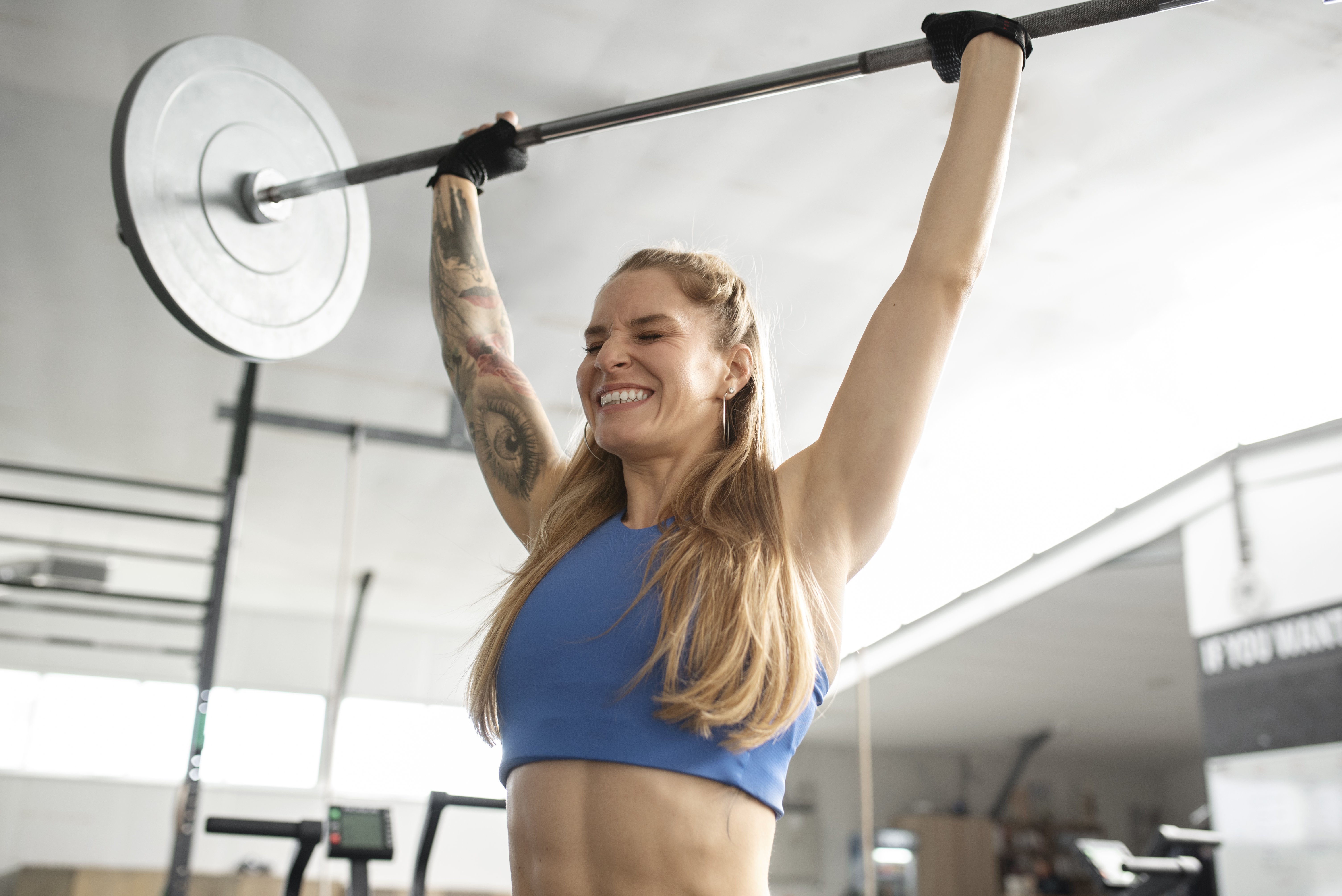 Patient performing a coached barbell exercise