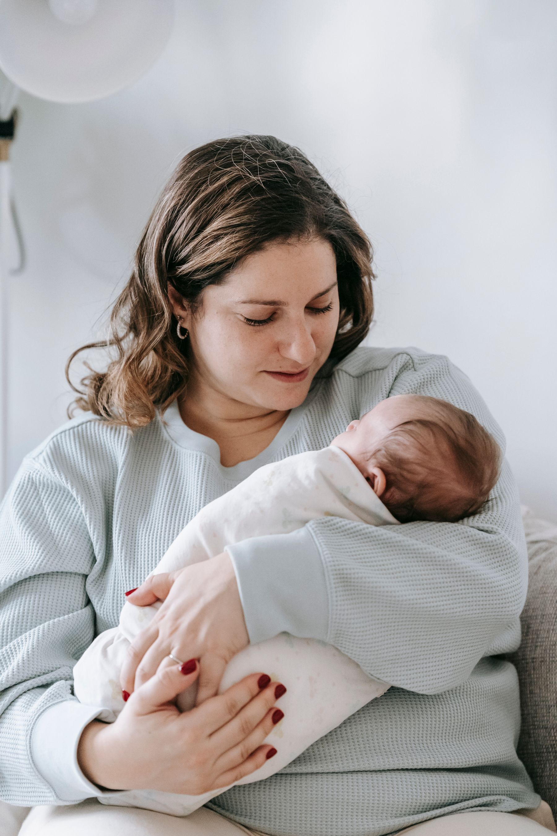 New mother at home with her baby